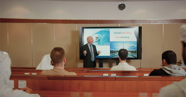 Image of a faculty teaching in the Dubai Campus of Abu Dhabi University