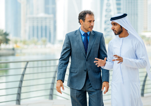 Two men discussing a business deal using skills developed in the Doctor of Business Administration