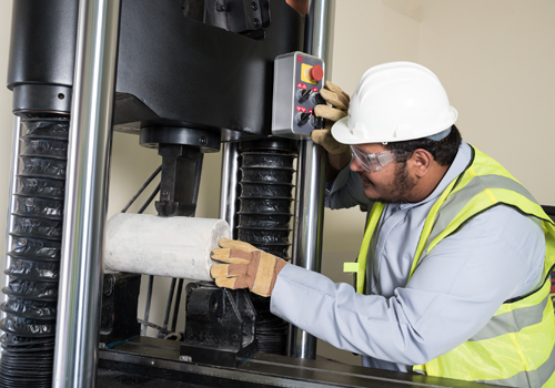 A Bachelor's degree in Civil Engineering student at Abu Dhabi University in hard hat and yellow jacket