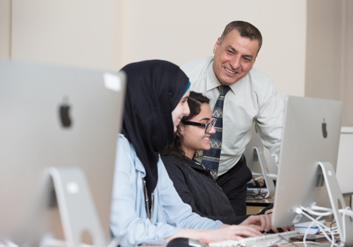 Professor teaching the Bachelor of Science in Information Technology to two female students