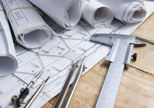 Master of Science in Civil Engineering plans and tools of the trade displayed on a table.