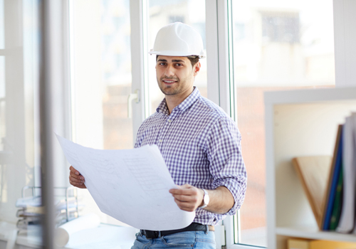 Civil Engineering Masters scholarship student holding engineering plans